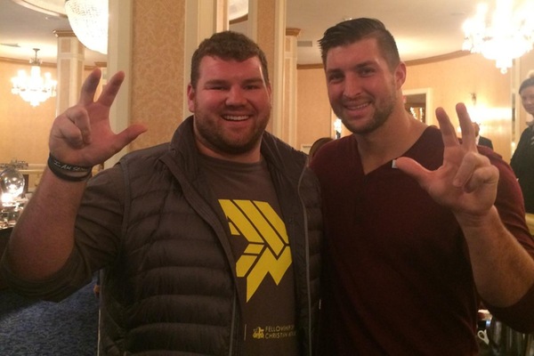 Allstate Good Works Team member Dan Gallman shows Heisman Trophy winner Tim Tebow how to get his Talons Up.