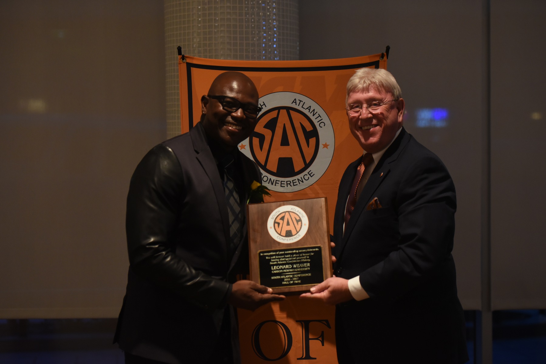 Leonard Weaver accepts his SAC Hall of Fame plaque from C-N Director of Athletics Allen Morgan