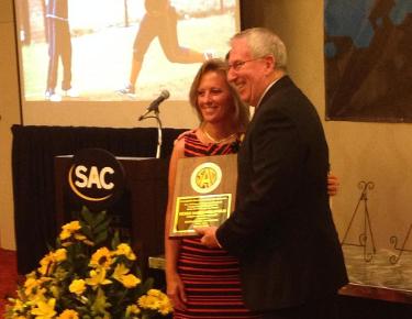 Carson-Newman head softball coach Vickee Kazee-Hollifield is presented her South Atlantic Conference Hall of Fame plaque by university president Dr. Randall O'Brien.